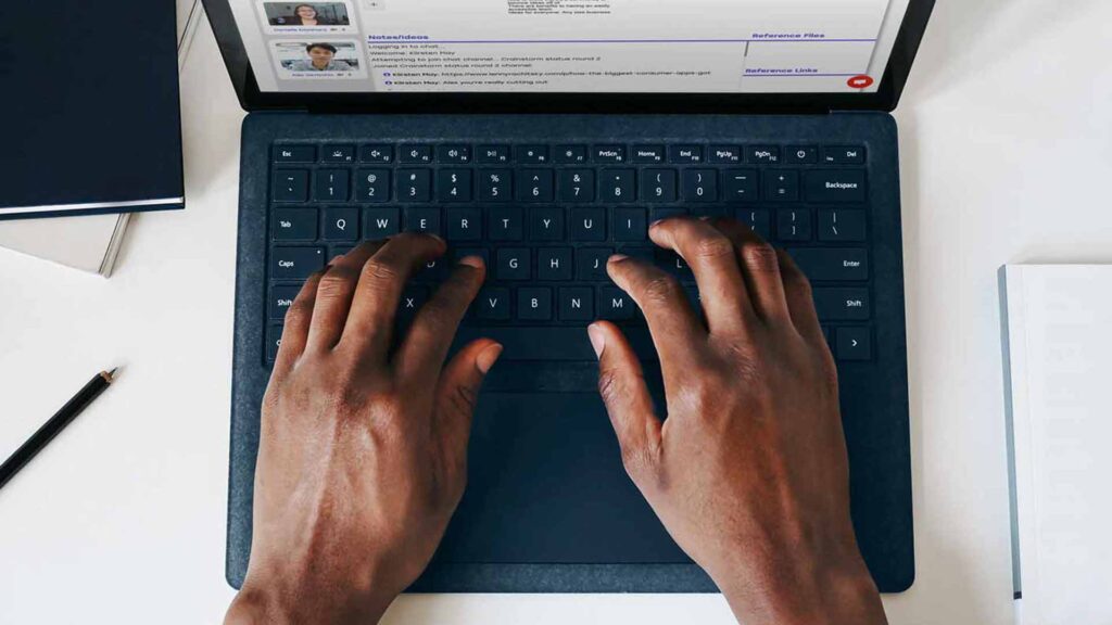 Overhead shot of hands on a laptop keyboard with a Crainstorm session on screen